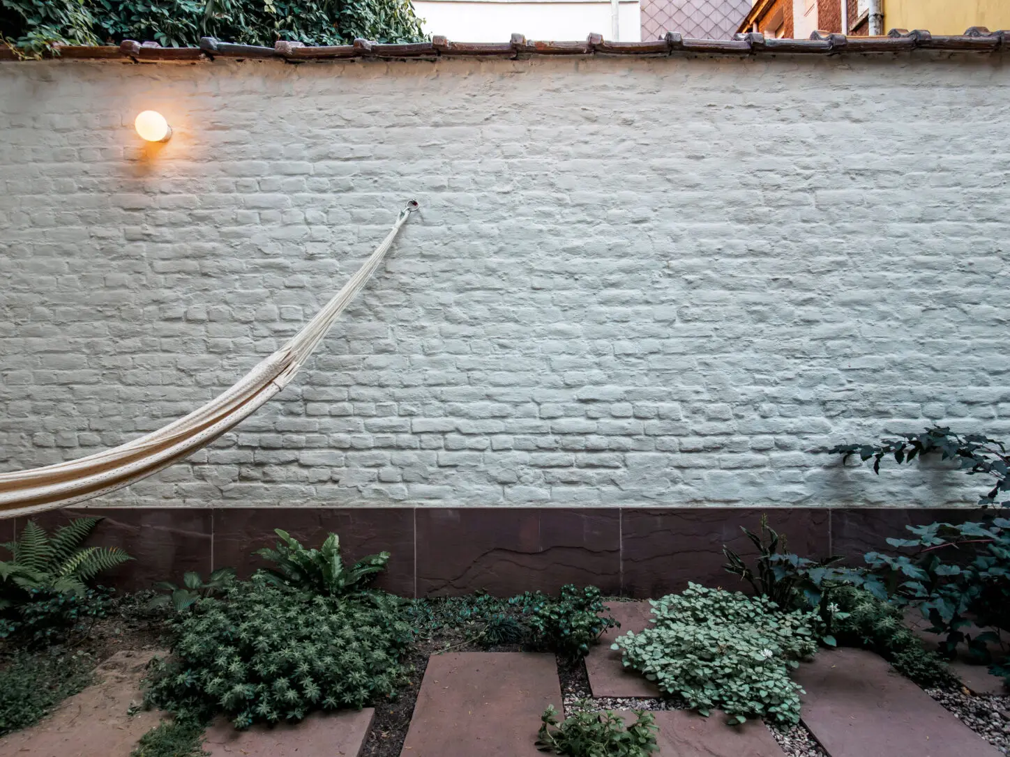 DELANNOY Renovation of a single-family house, Photo of back garden with re-used natural stone paving and open joints