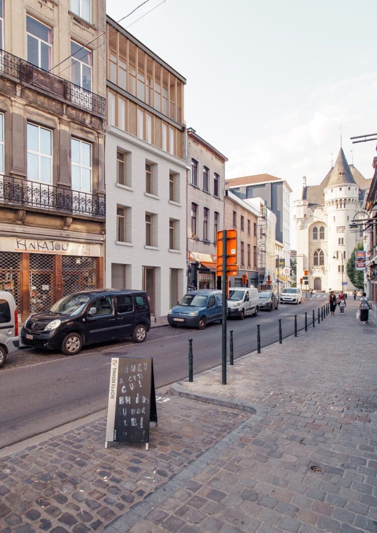 RUE HAUTE Circular renovation for social housing and retail, collage of the street facade with its lightweight roof extension